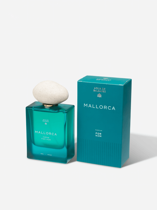 A turquoise rectangular perfume bottle with a pebble top with box on a white background. The bottle is labeled Mallorca For Him.
