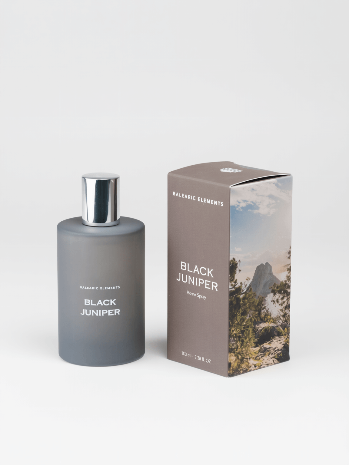 A bottle of Balearic Elements Black Juniper Eau de Spray next to its packaging box, set against a clean light gray background.
