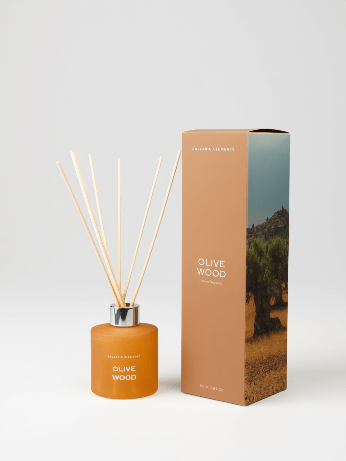 An olive wood reed diffuser bottle with natural reed sticks next to its matching packaging box, set against a clean light background.