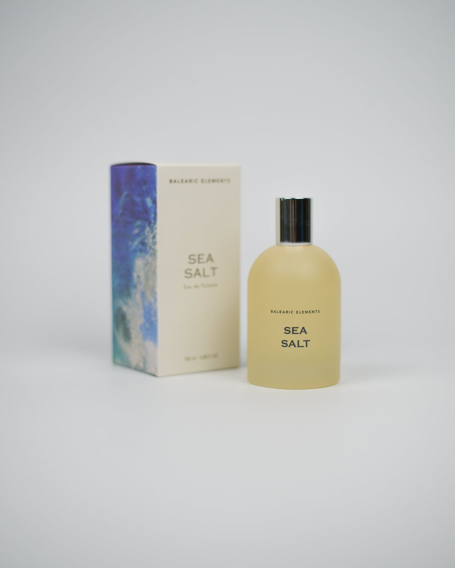 Bottle and box of Balearic Elements Sea Salt perfume on a white background