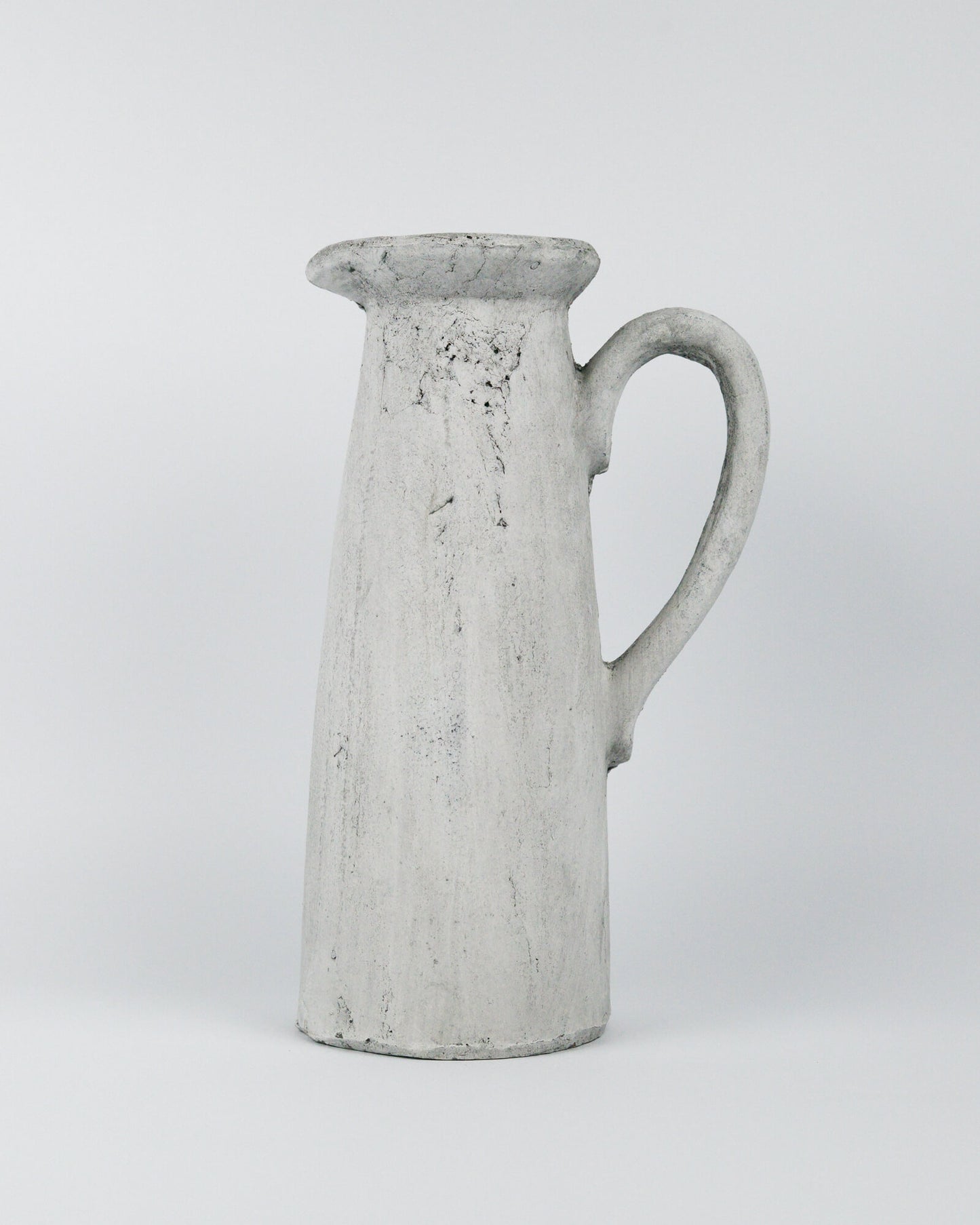 Grey ceramic pitcher on a white background