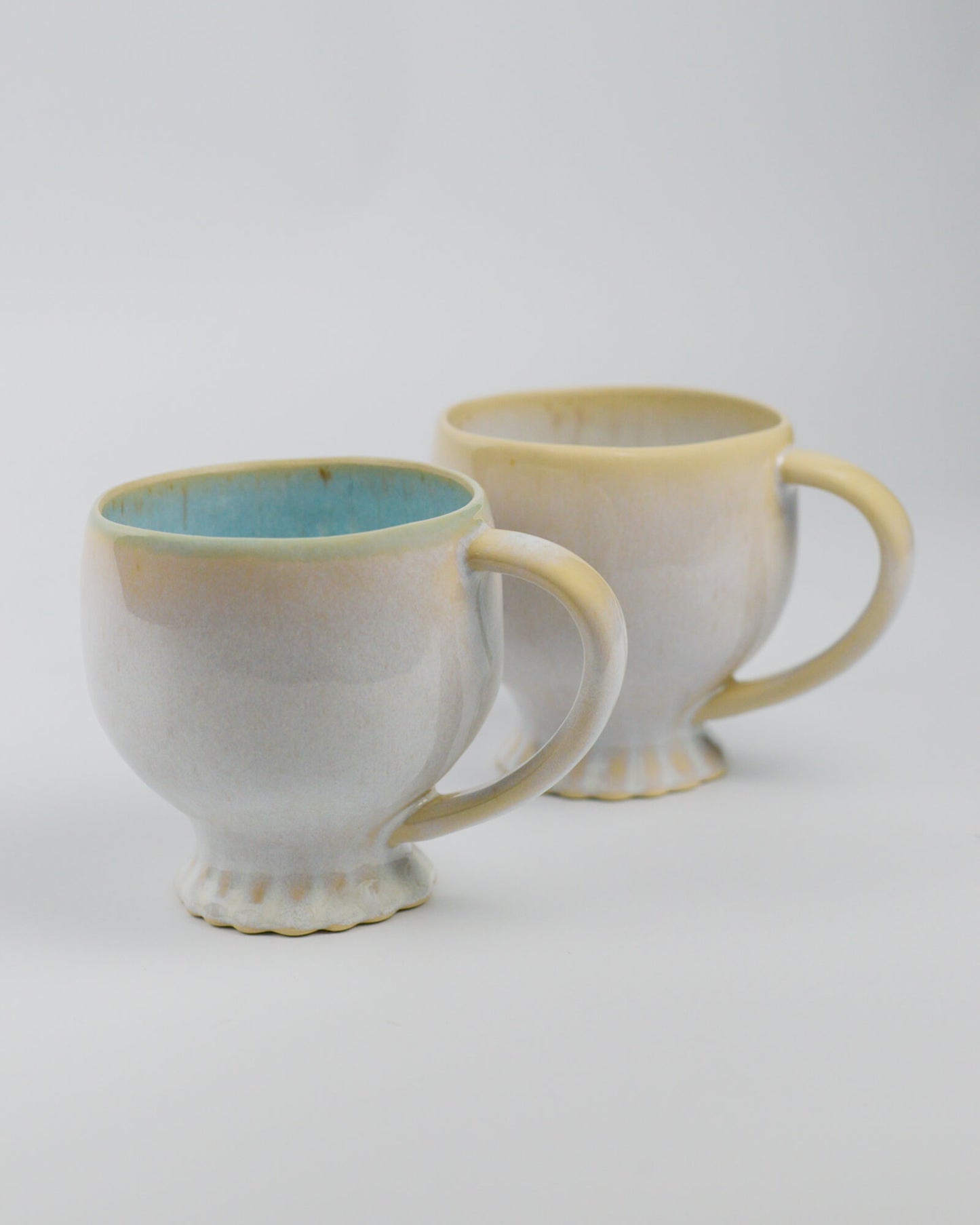 Two large ceramic mugs with a gradient finish on a white background