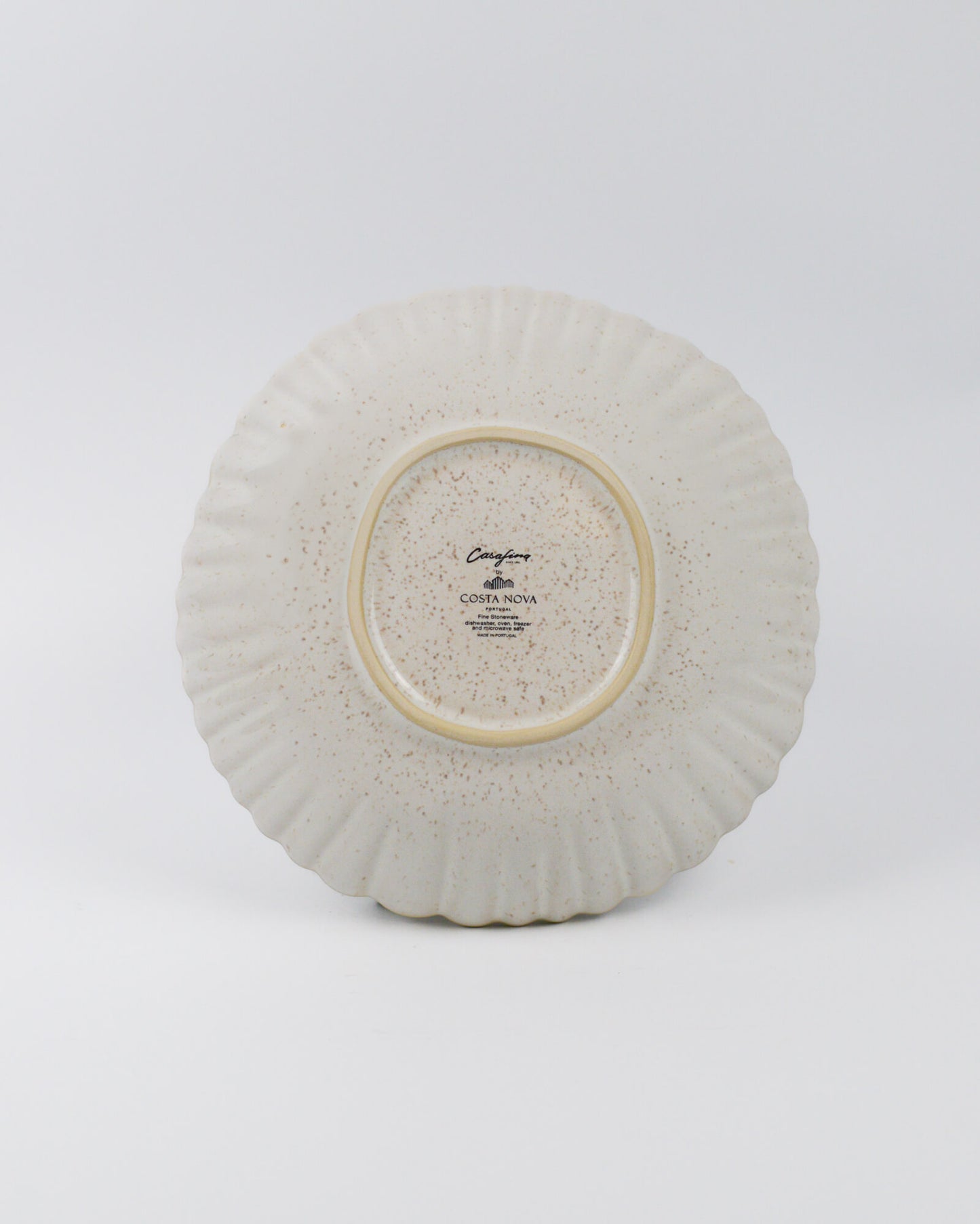 Ceramic pasta bowl with textured surface on a white background