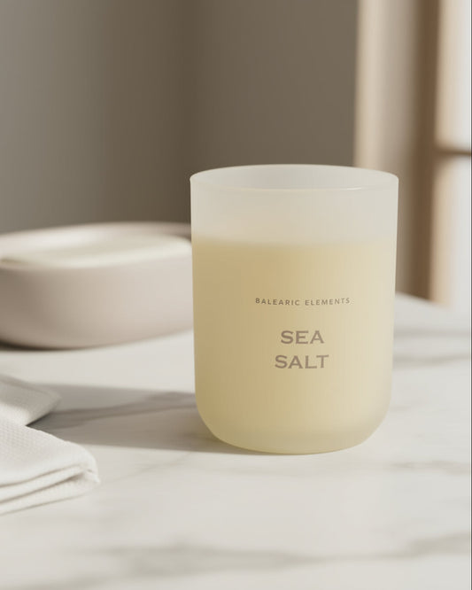 Scented candle labeled 'Sea Salt' on a neutral background