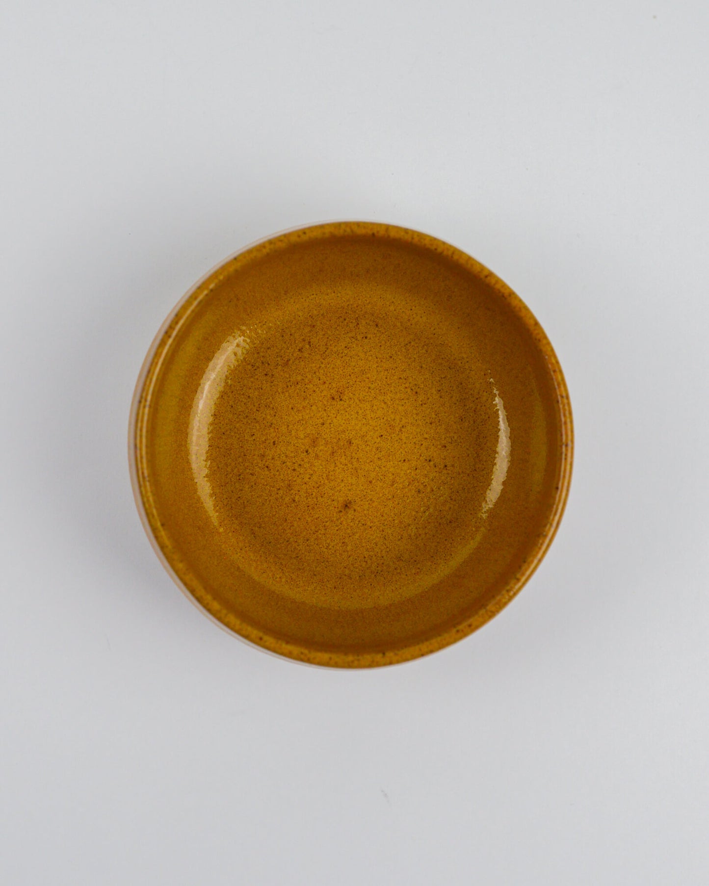 Yellow ceramic bowl on a white background