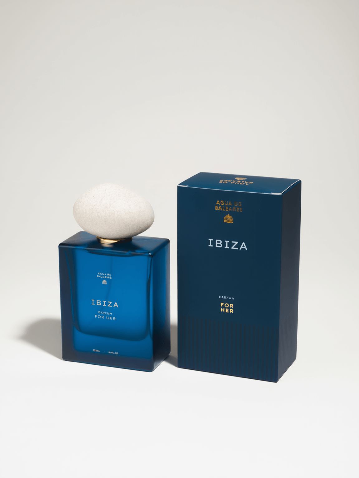 A blue rectangular perfume bottle labeled 'IBIZA' sits on a white background with it's box