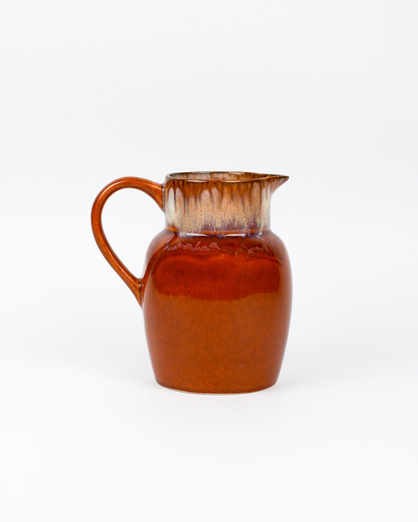 Burnt caramel ceramic glazed picher on a white background