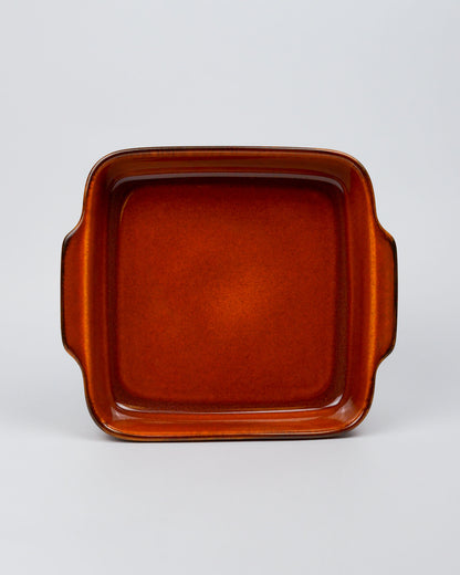Burnt orange square stoneware ceramic baking dish on a white background