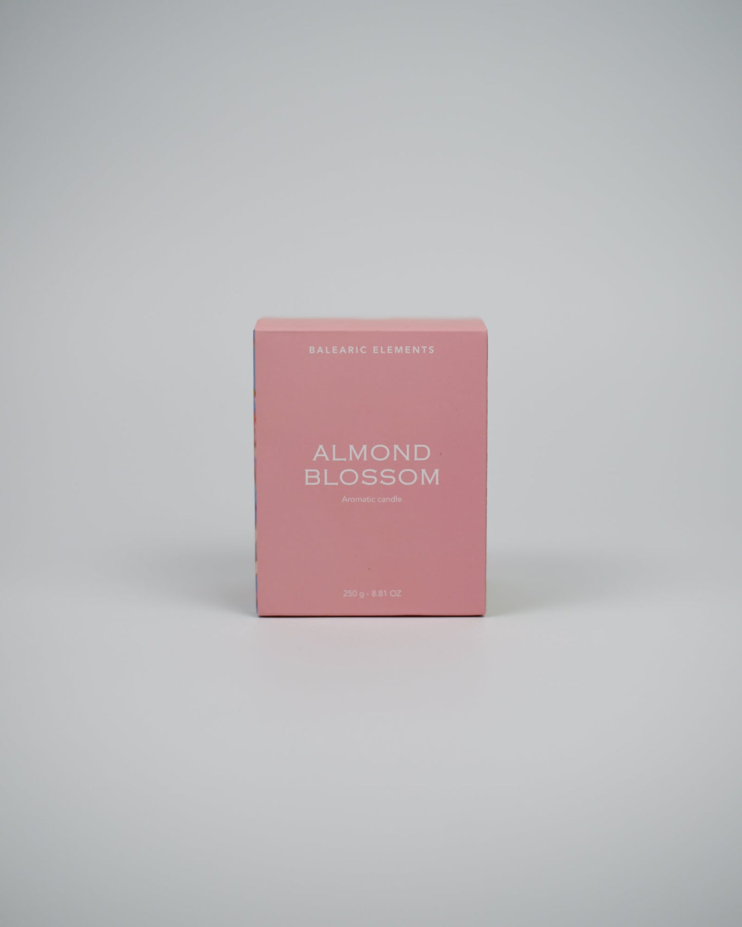 Pink candle box labeled 'Almond Blossom' on a white background