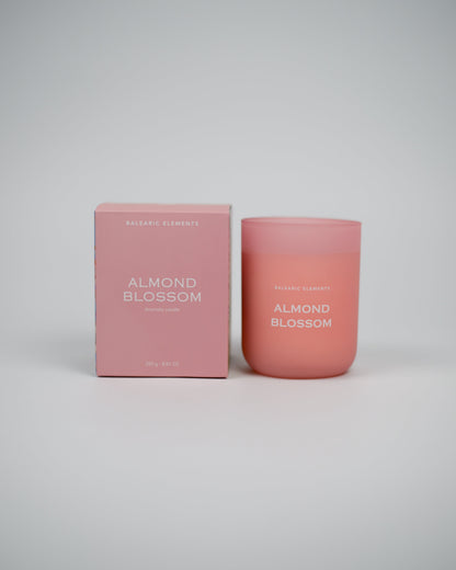 Pink 'Almond Blossom' scented candle and packaging on a white background