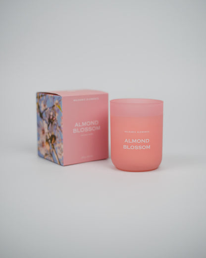Pink 'Almond Blossom' scented candle and packaging on a white background