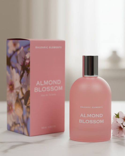 Pink 'Almond Blossom' perfume bottle and packaging on a light surface with a blurred background