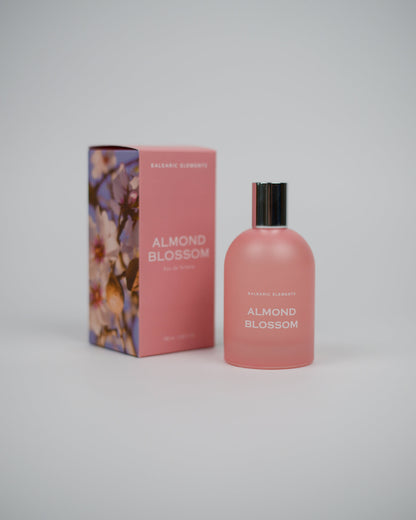 Pink 'Almond Blossom' perfume bottle and packaging on a white background