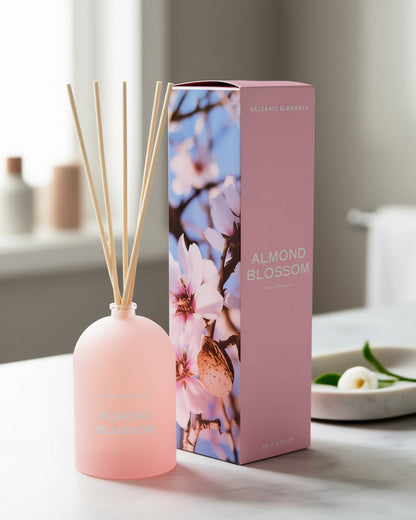 Pink diffuser bottle with almond blossom packaging on a table