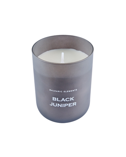 Candle in a gray container labeled 'Black Juniper' on a white background