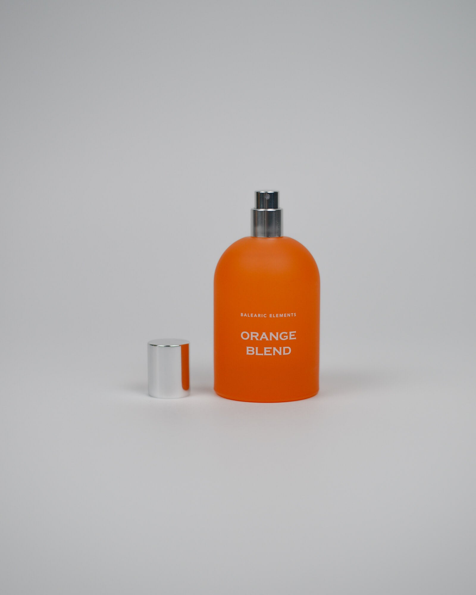 Orange perfume bottle labeled 'Orange Blend' on a white background