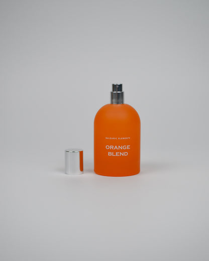 Orange perfume bottle labeled 'Orange Blend' on a white background