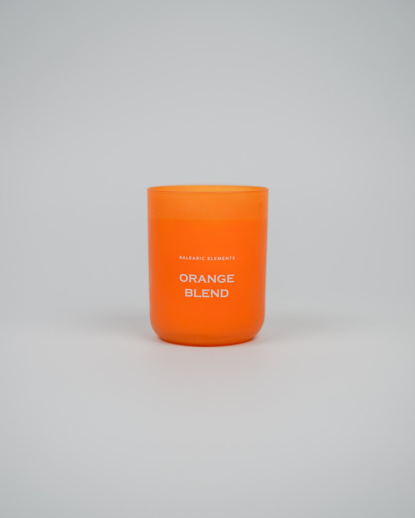 Orange scented candle labeled 'Orange Blend' on a white background
