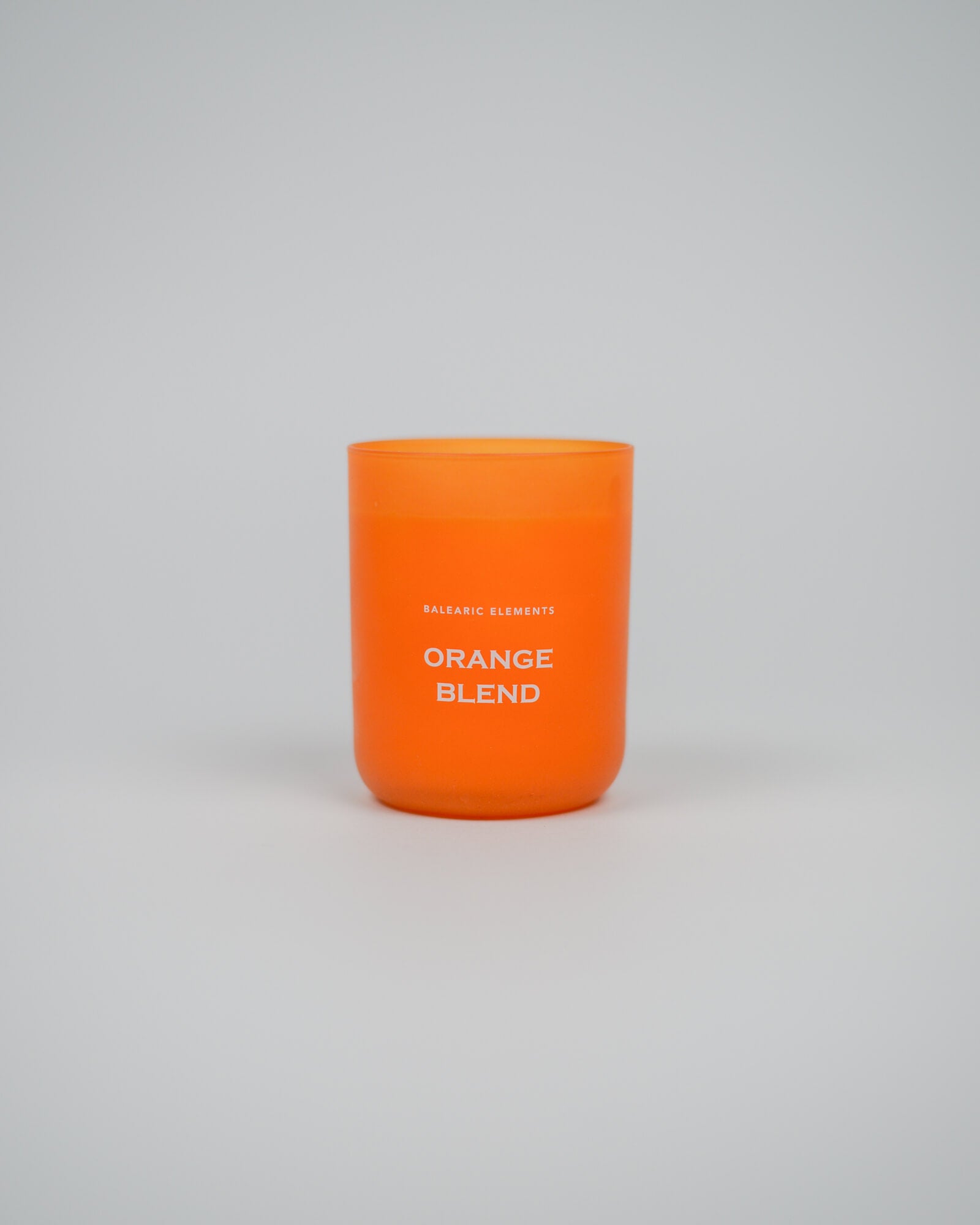 Orange scented candle labeled 'Orange Blend' on a white background