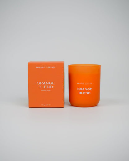 Orange scented candle and packaging with 'Orange Blend' text on a white background