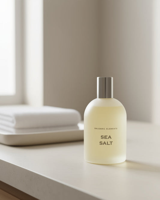 Sea Salt Unisex Eau de Toilette on a neutral marble surface with a washcloth in the background 