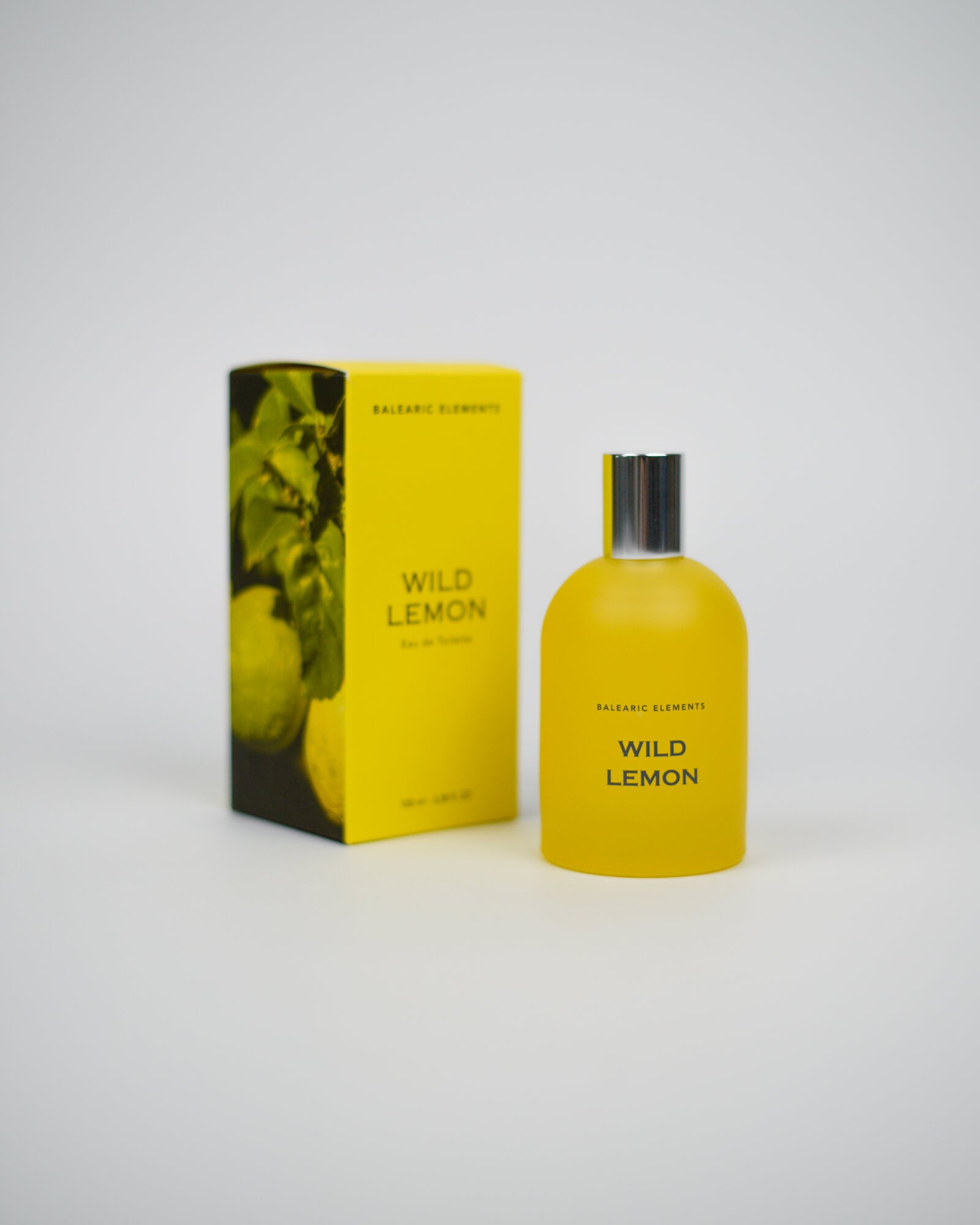 Yellow 'Wild Lemon' perfume bottle and packaging on a white background
