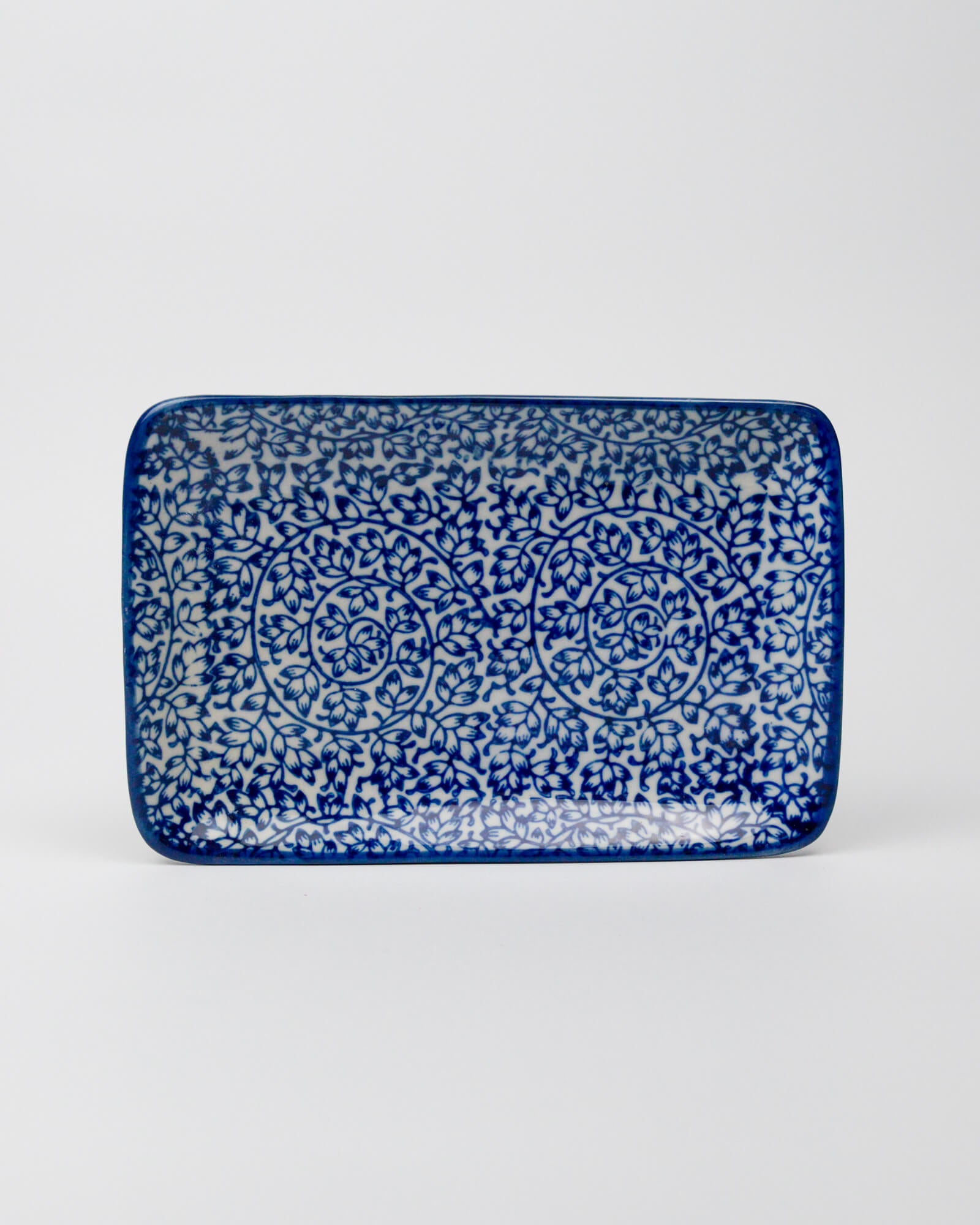 Rectangular ceramic tray with blue and white pattern on a white background