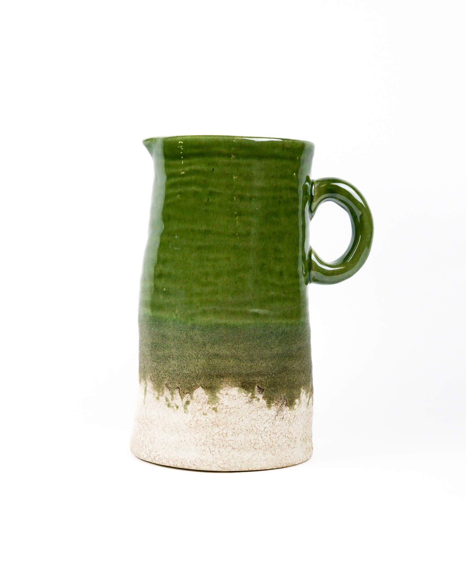 Olive green ceramic pitcher with a white base on a white background