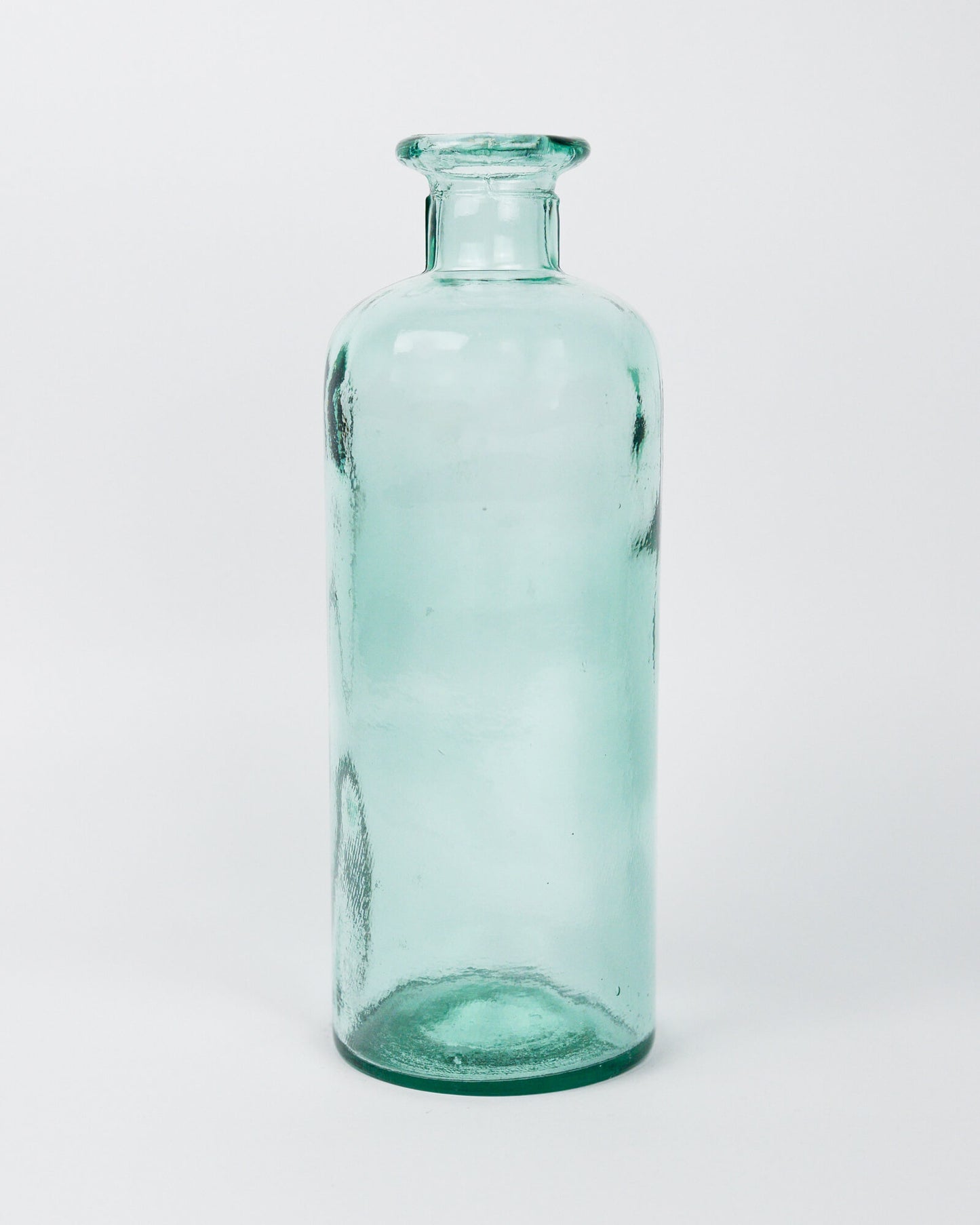 Green glass decorative bottle vase on a white background