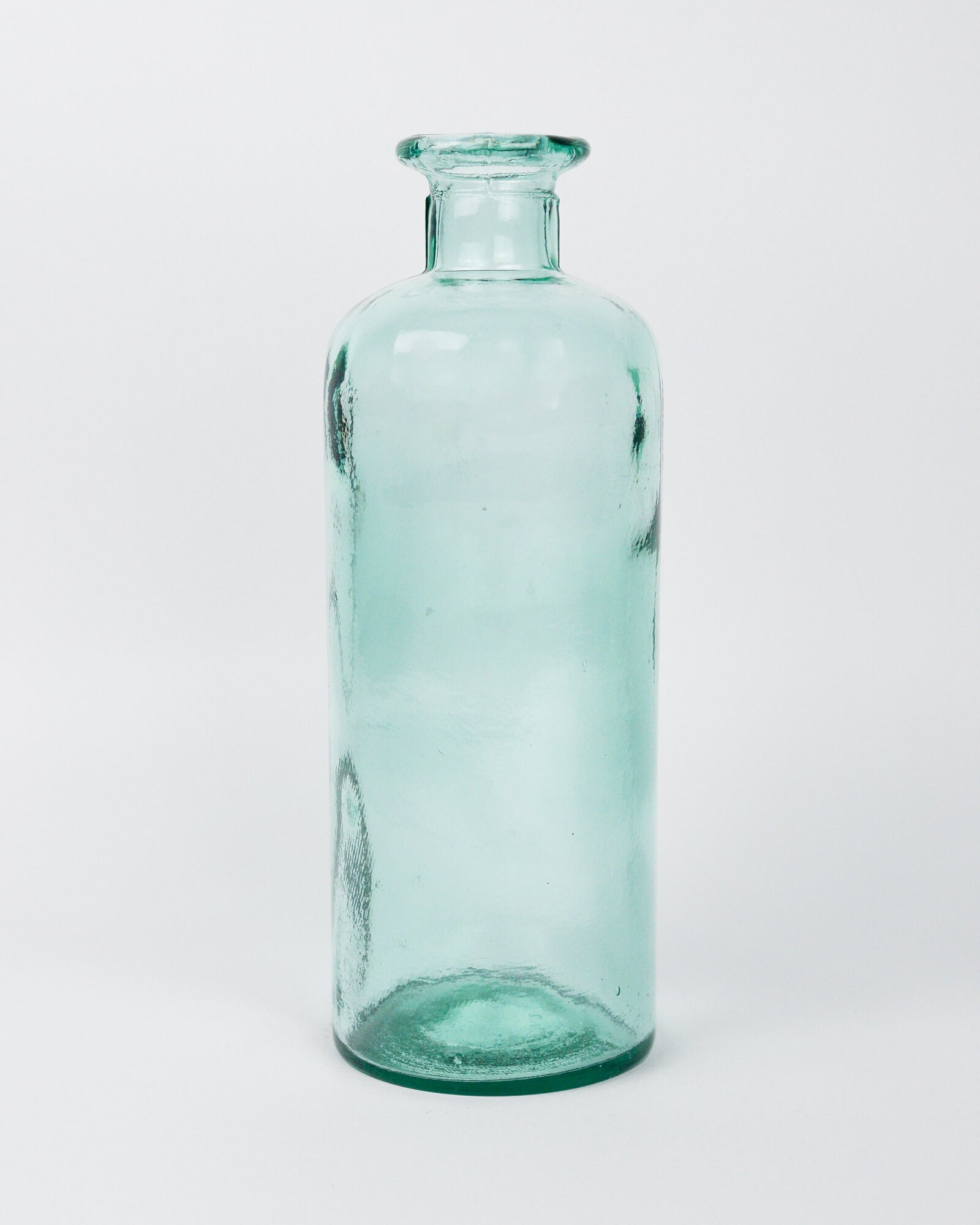 Green glass decorative bottle vase on a white background