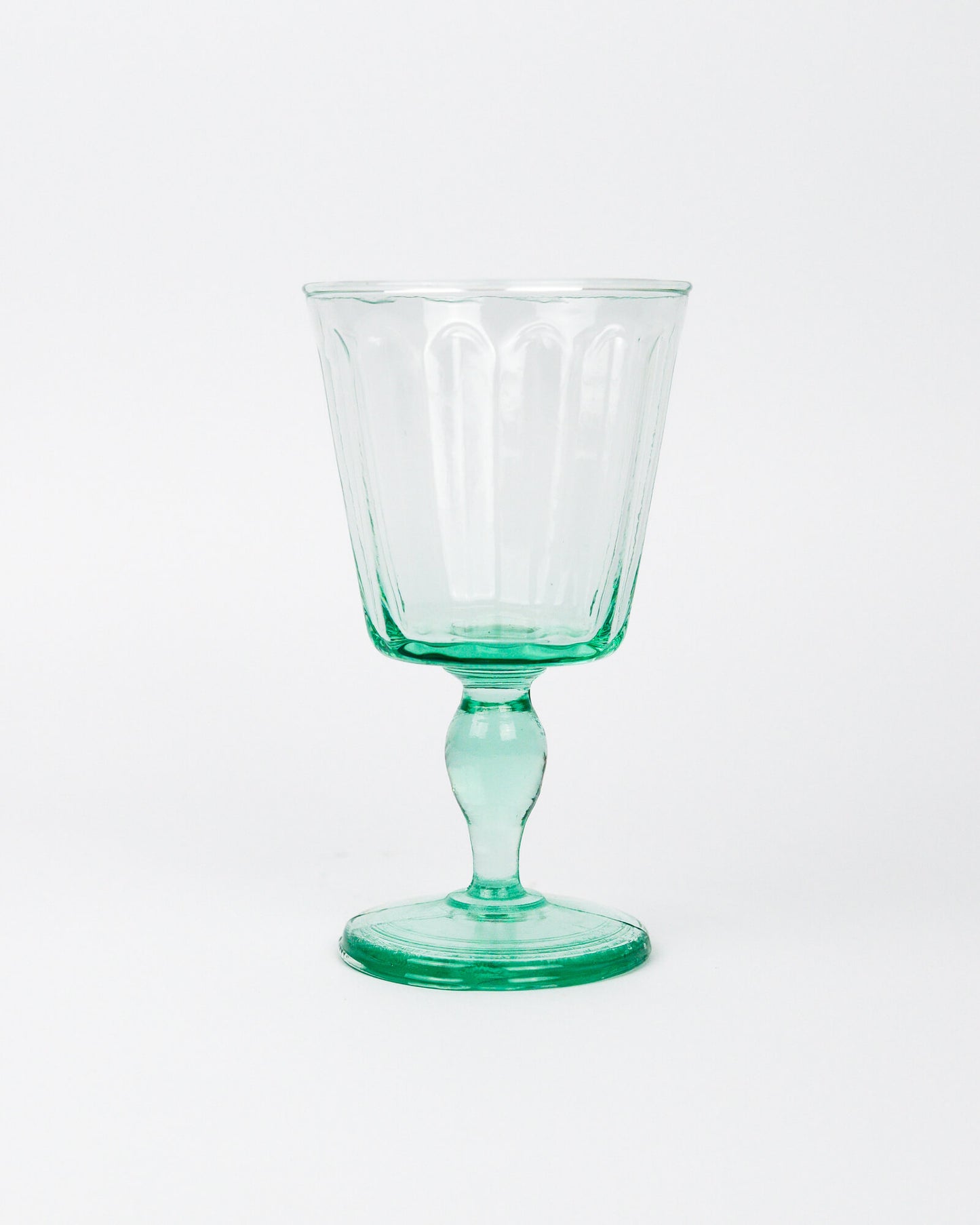 Green wine glass goblet on a white background