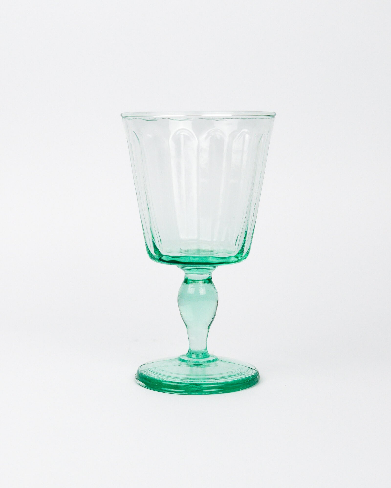 Green wine glass goblet on a white background