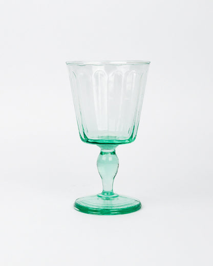 Green wine glass goblet on a white background