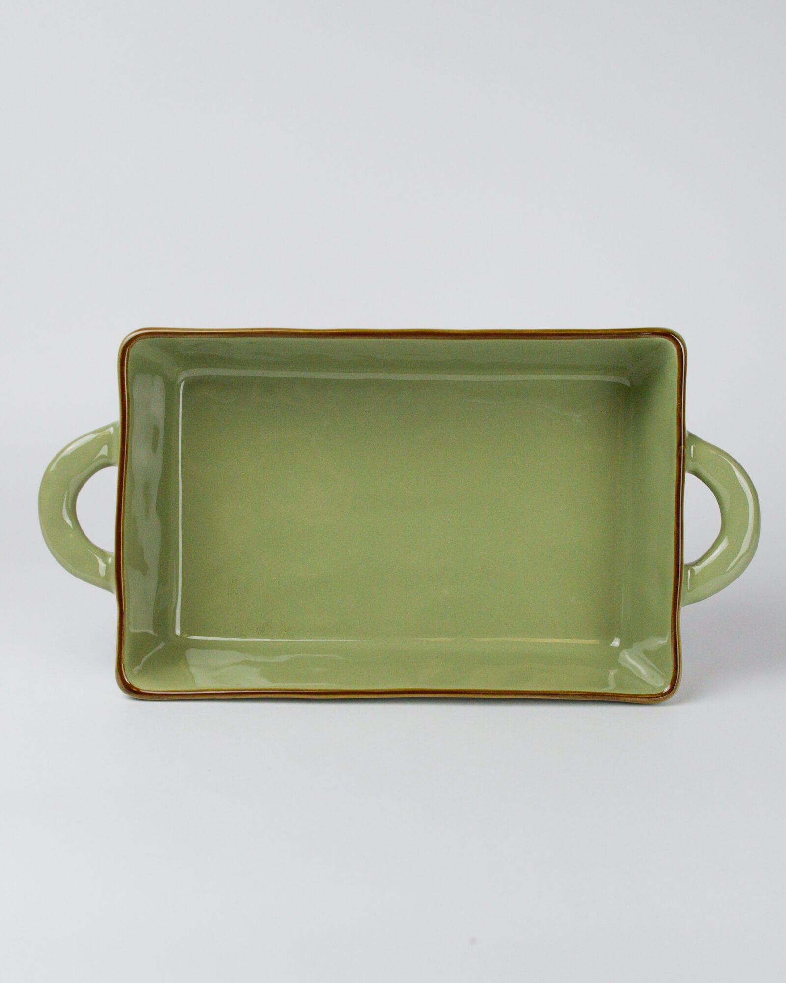 Green rectangular ceramic dish with handles on a white background