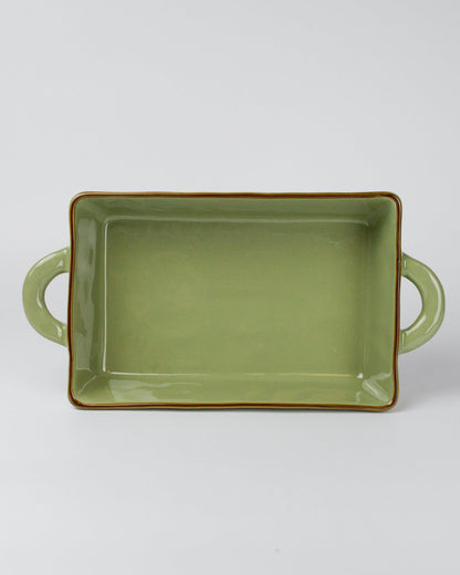 Green rectangular ceramic dish with handles on a white background