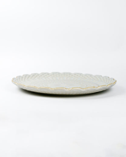 Decorative ceramic plate with textured design on a white background