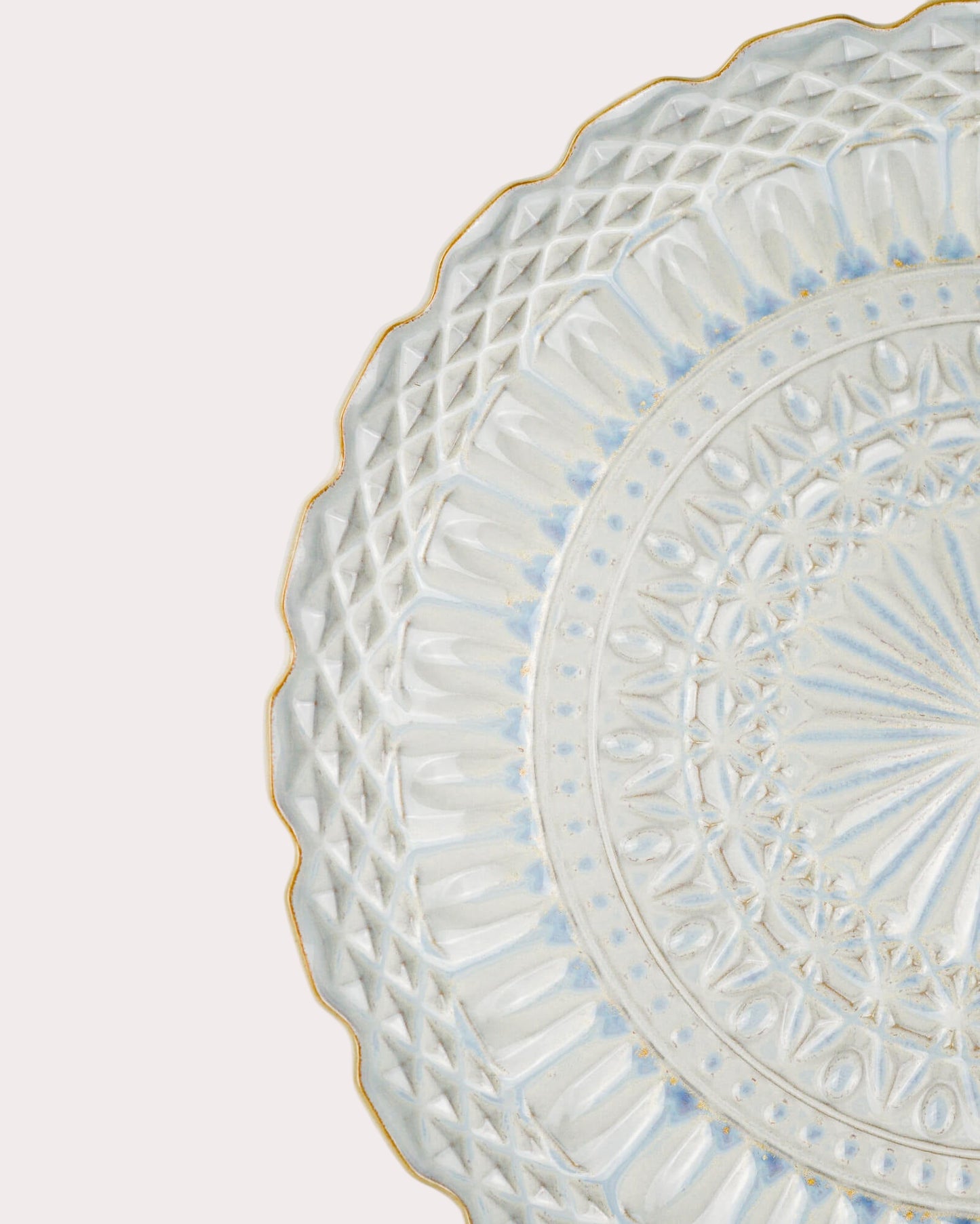 Decorative ceramic plate with intricate patterns on a white background