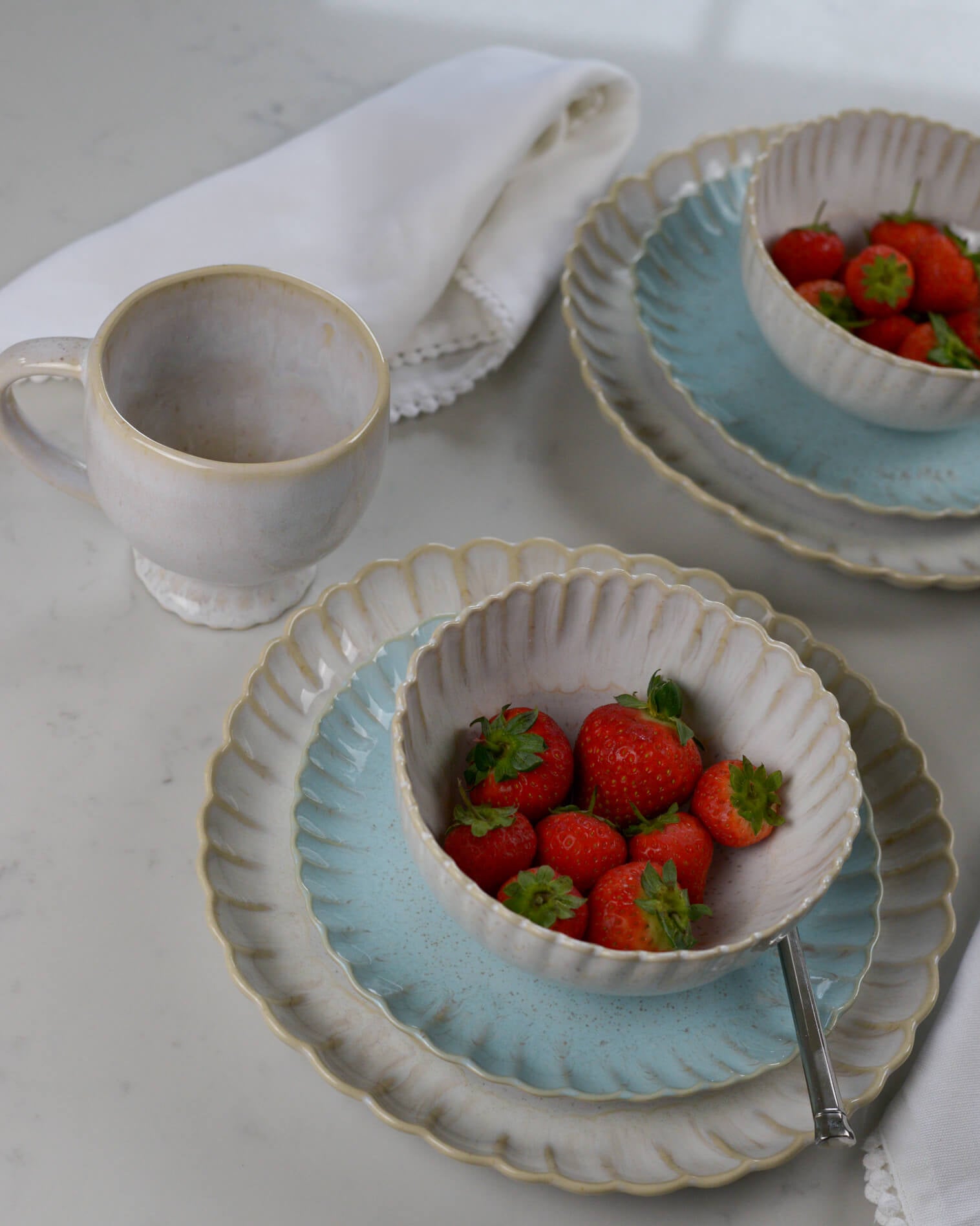 Scalloped edge breakfast mug with matching plates and cereal bowls