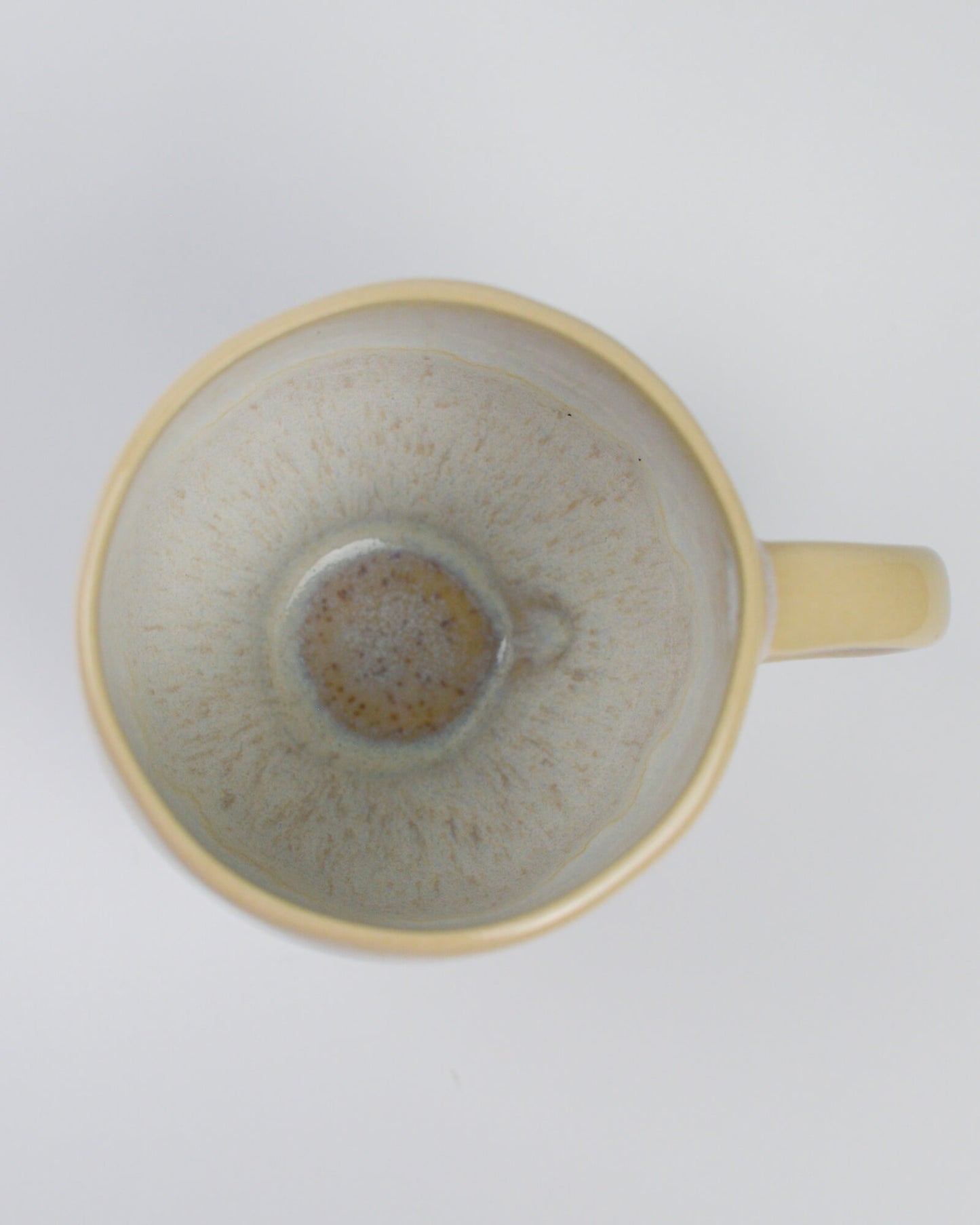 Ceramic teacup with handle on a white background