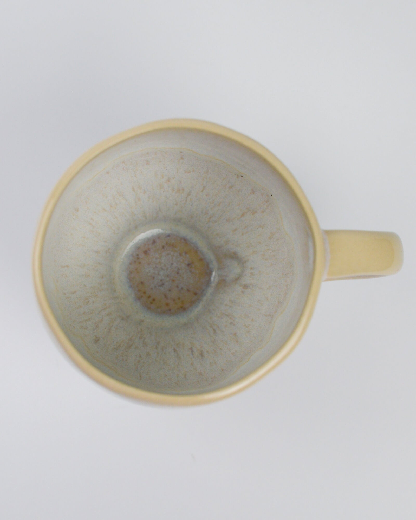 Ceramic teacup with handle on a white background