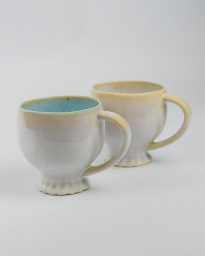 Two large ceramic mugs with a gradient finish on a white background