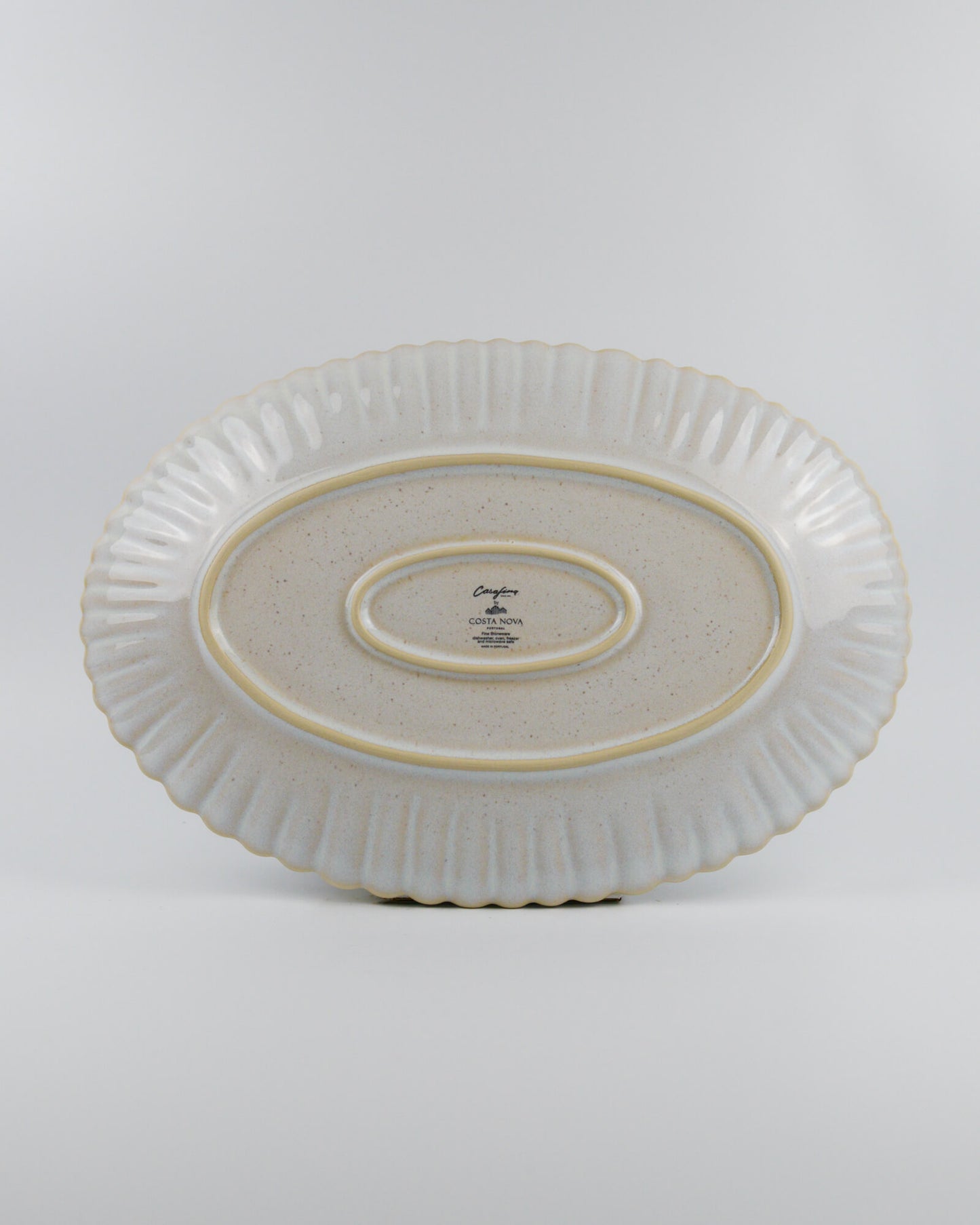 Ceramic oval platter with textured design on a white background