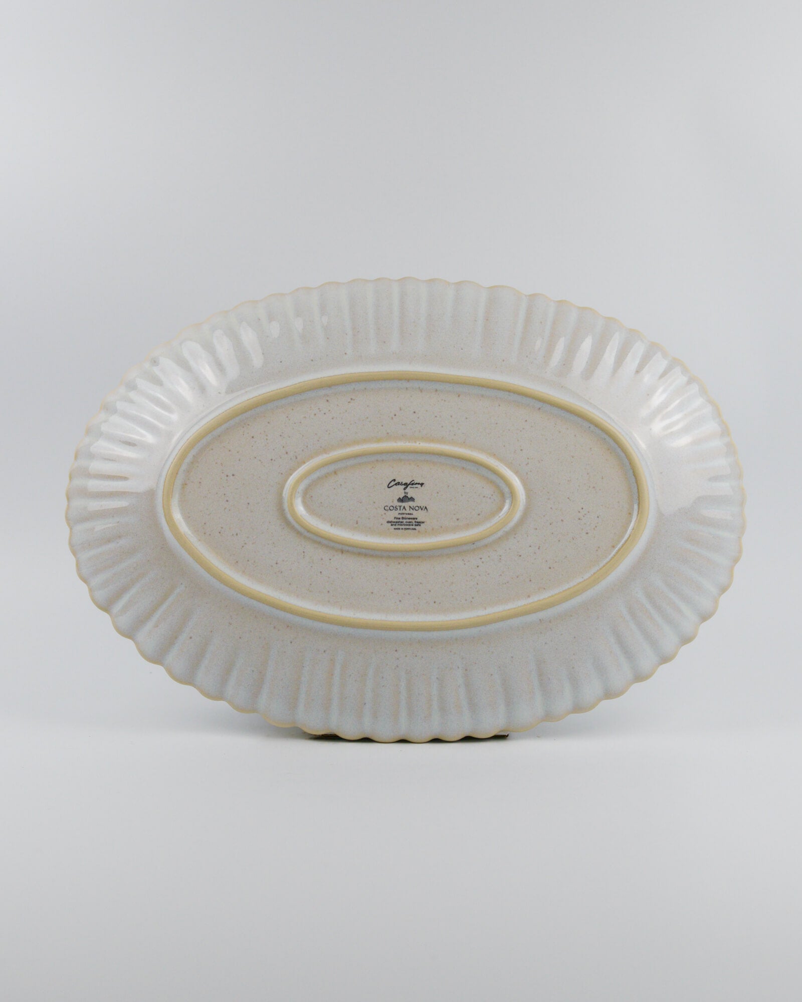 Ceramic oval platter with textured design on a white background