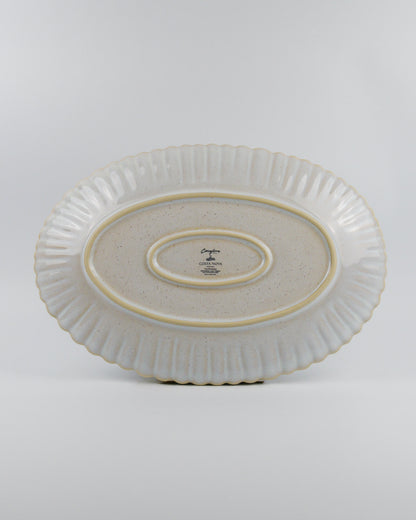 Ceramic oval platter with textured design on a white background