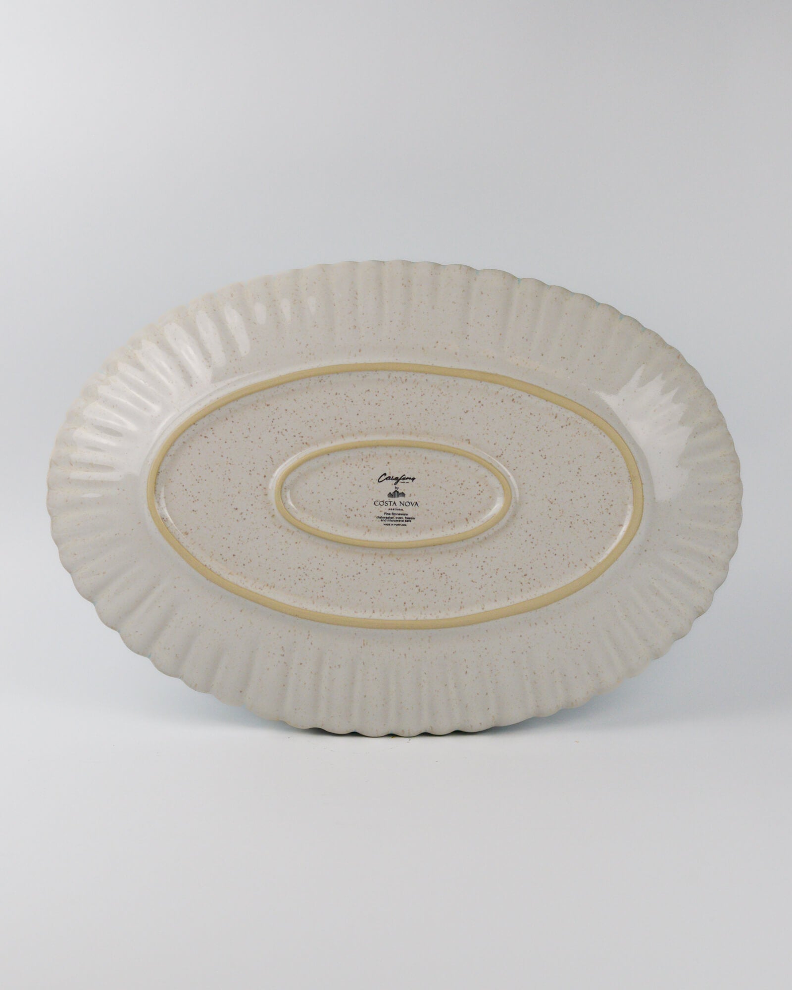 Decorative ceramic oval platter with textured design on a white background