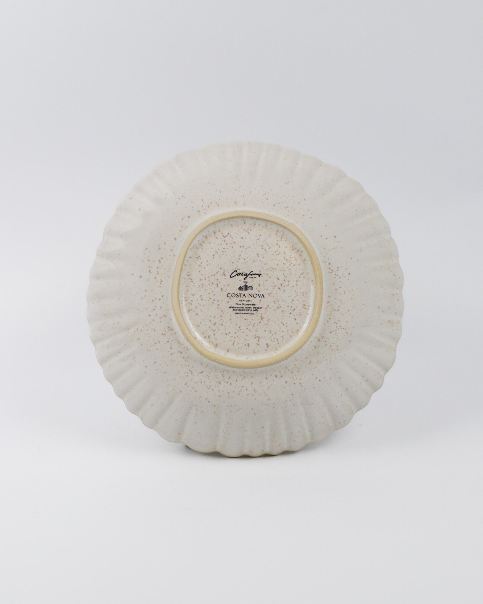 Ceramic pasta bowl with textured surface on a white background
