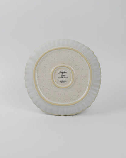 Round ceramic salad plate with textured surface on a white background