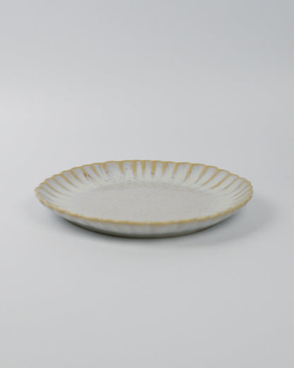 Ceramic salad plate in beige white on a white background