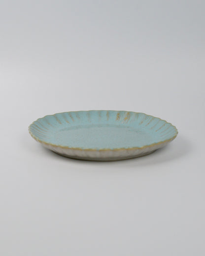 Turquoise ceramic plate on a white background