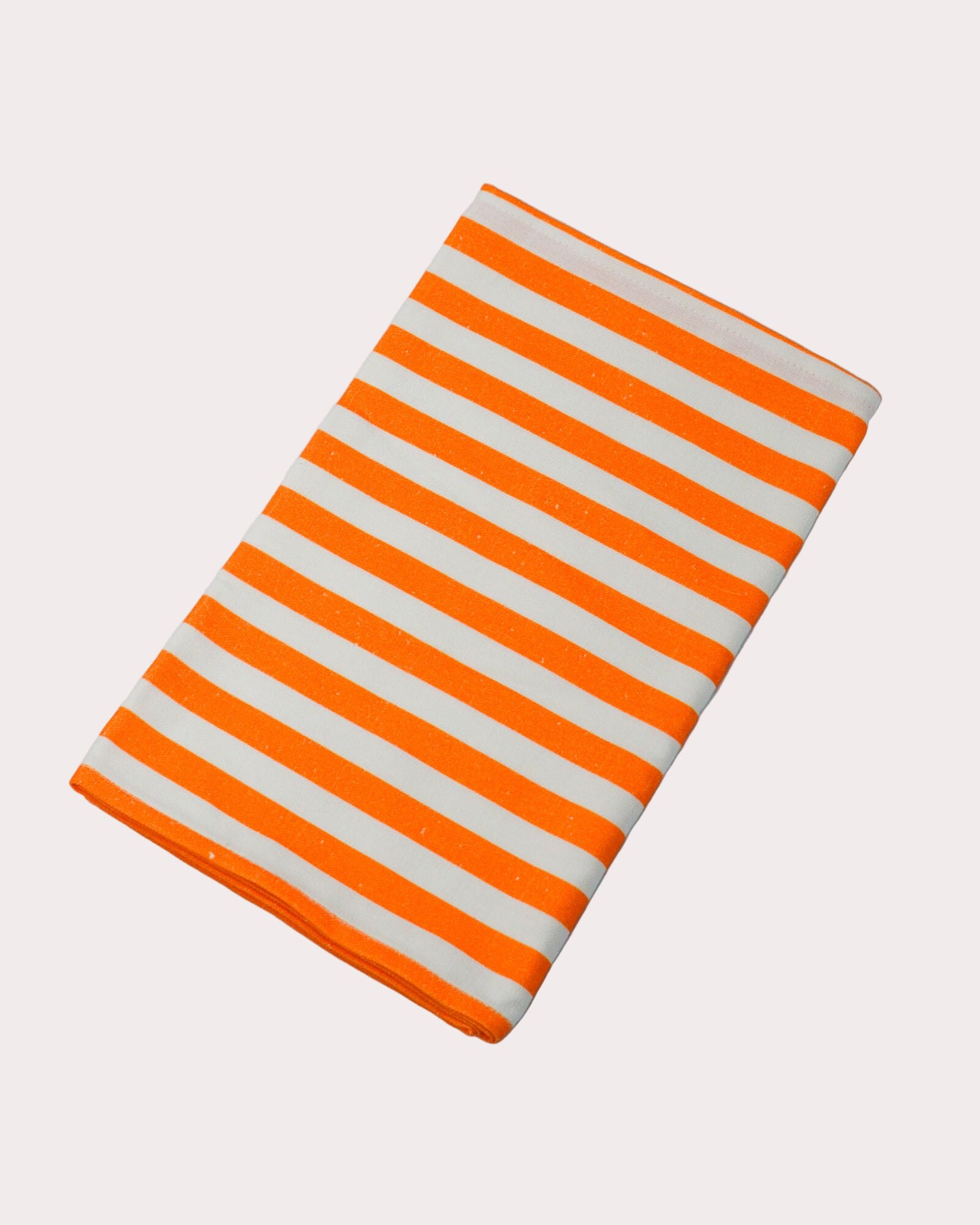 Rectangular cotton and linen blend table runner with orange and white stripes on a white background